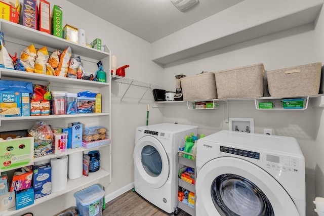 laundry room featuring hardwood / wood-style flooring and washing machine and clothes dryer