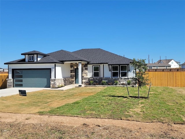 view of front of house featuring a garage and a front yard