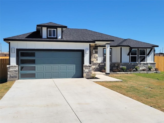 view of front of house with a garage and a front lawn