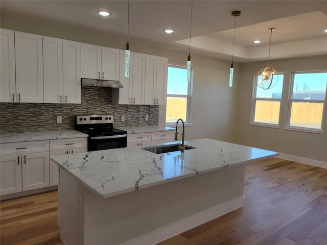 kitchen featuring white cabinets, stainless steel electric stove, sink, and an island with sink