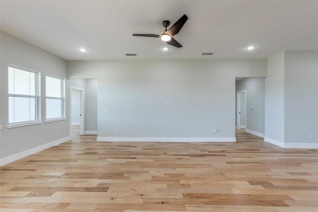 unfurnished room featuring visible vents, a ceiling fan, and light wood finished floors