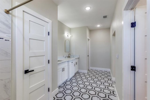 full bathroom with visible vents, double vanity, baseboards, recessed lighting, and a sink