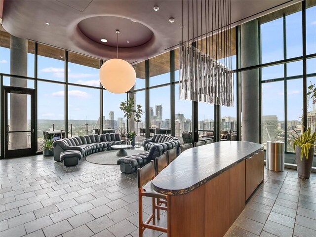 44 E Ave Unit 1407, Austin, TX 78701 - common area with floor to ceiling windows, a skyline view, a towering ceiling, and recessed lighting