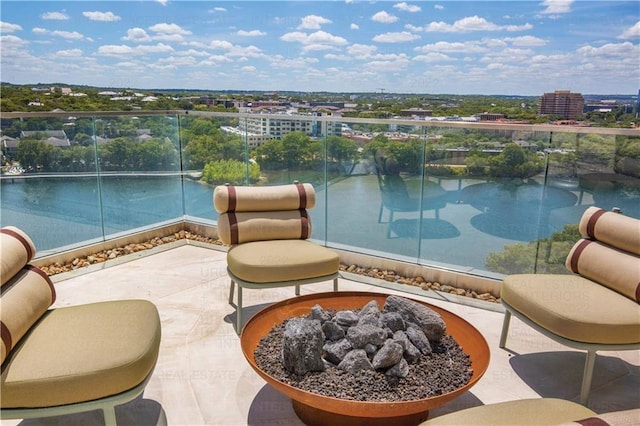 balcony featuring an outdoor fire pit and a patio area