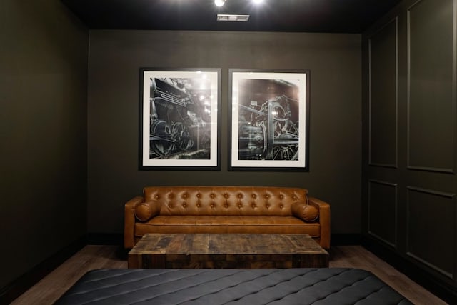 home theater room featuring hardwood / wood-style floors