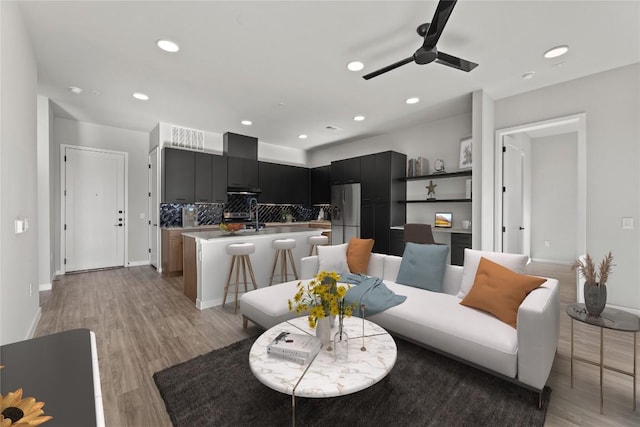 dining area featuring ceiling fan and light wood-type flooring