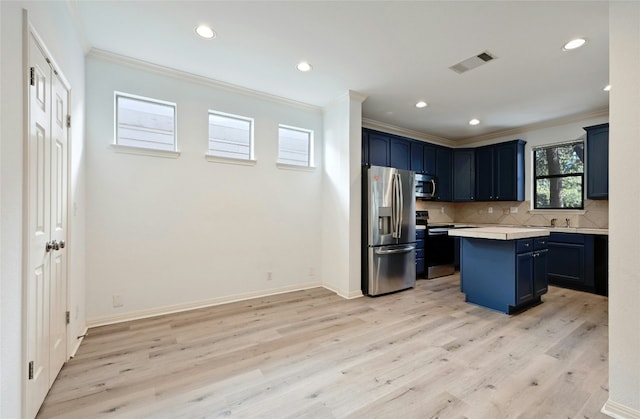 kitchen with appliances with stainless steel finishes, decorative backsplash, ornamental molding, a center island, and blue cabinetry