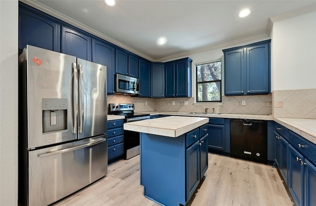 kitchen with crown molding, appliances with stainless steel finishes, blue cabinets, and a kitchen island