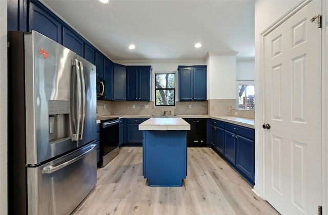 kitchen featuring a kitchen island, tasteful backsplash, blue cabinets, stainless steel appliances, and crown molding