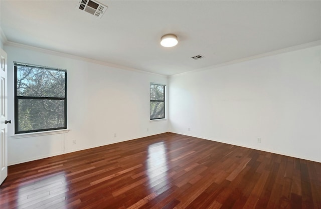 spare room with crown molding and dark hardwood / wood-style flooring