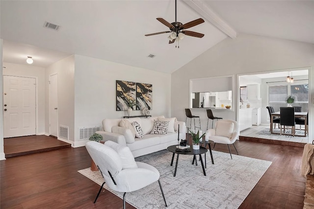 living area featuring beam ceiling, visible vents, and wood finished floors