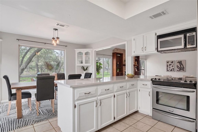 kitchen with a wealth of natural light, light countertops, appliances with stainless steel finishes, and visible vents