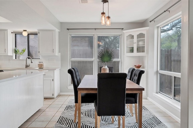 dining area with visible vents, baseboards, and light tile patterned floors