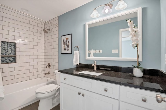 bathroom featuring tub / shower combination, vanity, and toilet