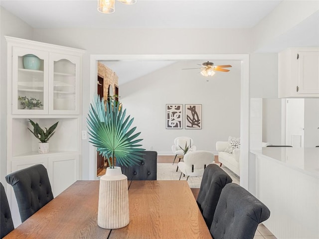 dining space featuring ceiling fan and vaulted ceiling