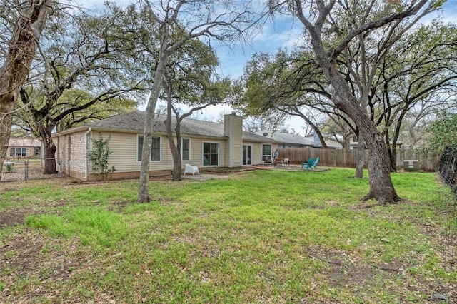 view of yard with a patio area and a fenced backyard