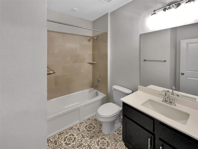 full bathroom featuring tile patterned flooring, tiled shower / bath, vanity, and toilet