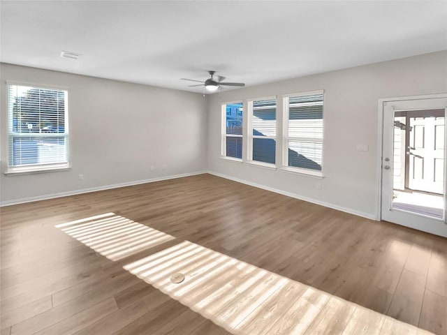 spare room with wood-type flooring and ceiling fan