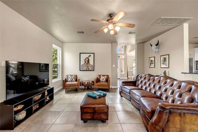 tiled living room featuring ceiling fan