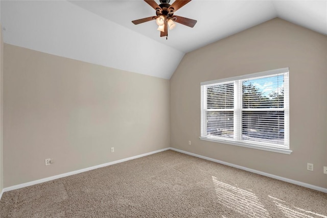 carpeted empty room with ceiling fan and lofted ceiling