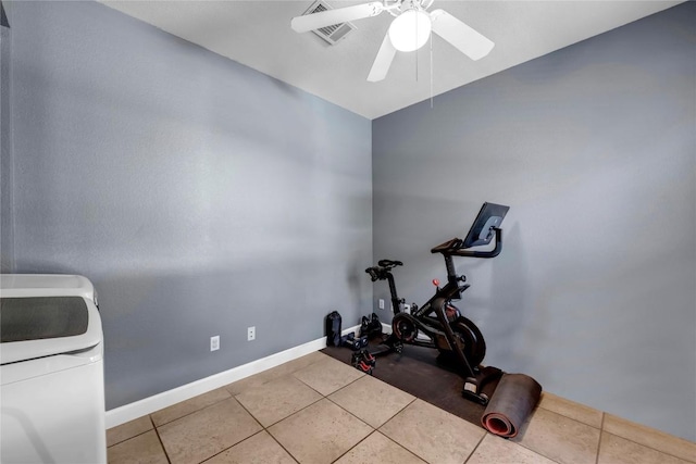 workout area with washer / dryer, light tile patterned floors, and ceiling fan