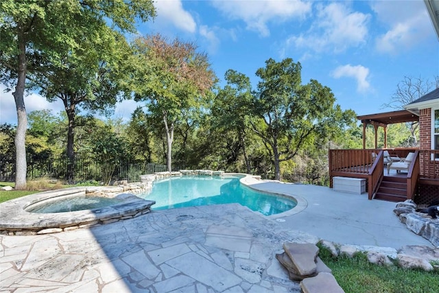 view of swimming pool with an in ground hot tub, a deck, and a patio