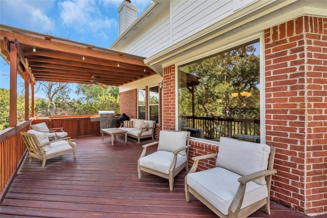 wooden deck with ceiling fan, grilling area, and outdoor lounge area