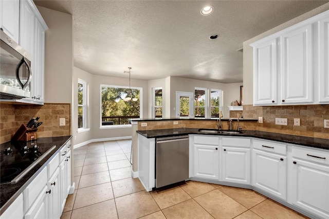 kitchen featuring kitchen peninsula, sink, and white cabinets