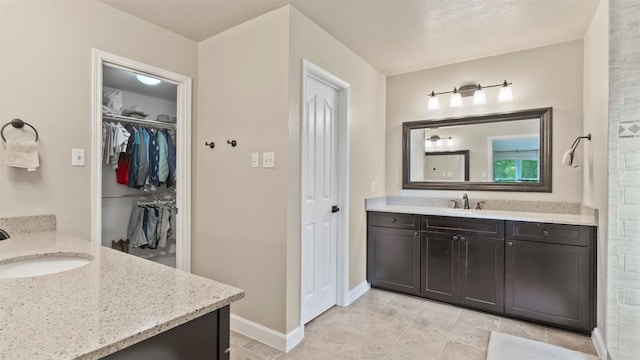 31108 La Quinta Dr, Georgetown, TX 78628 - bathroom with two vanities and a walk in closet