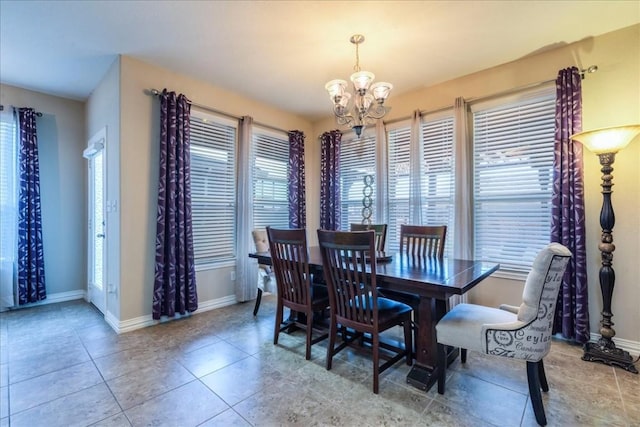 dining room with light tile patterned floors and a chandelier