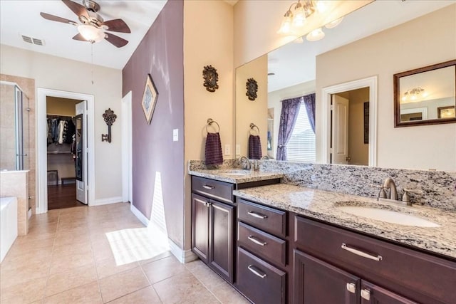 bathroom featuring vanity, tile patterned flooring, plus walk in shower, and ceiling fan