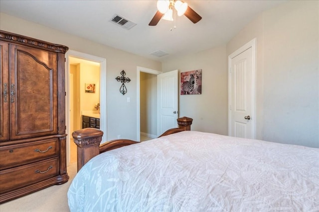 bedroom featuring ensuite bathroom, carpet flooring, and ceiling fan