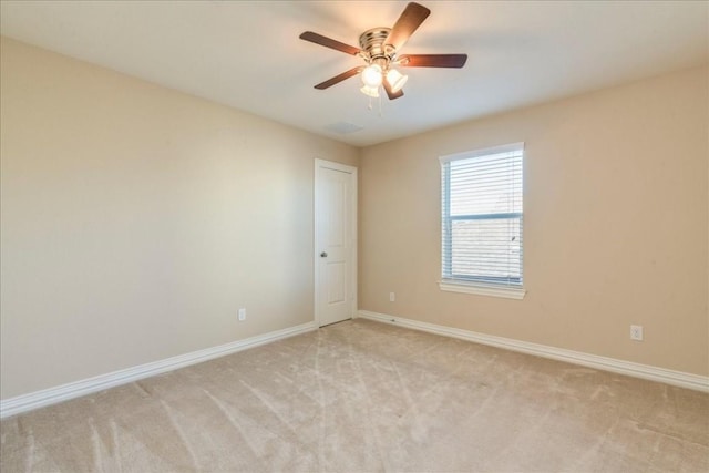 empty room with light carpet and ceiling fan