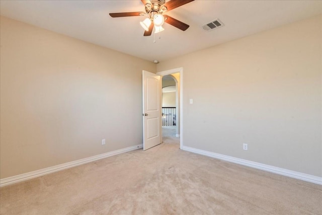 unfurnished room with ceiling fan and light colored carpet