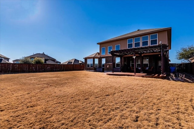 rear view of house featuring a pergola and a patio area