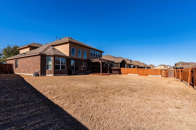 back of property featuring a pergola