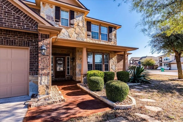 entrance to property featuring a porch and a garage