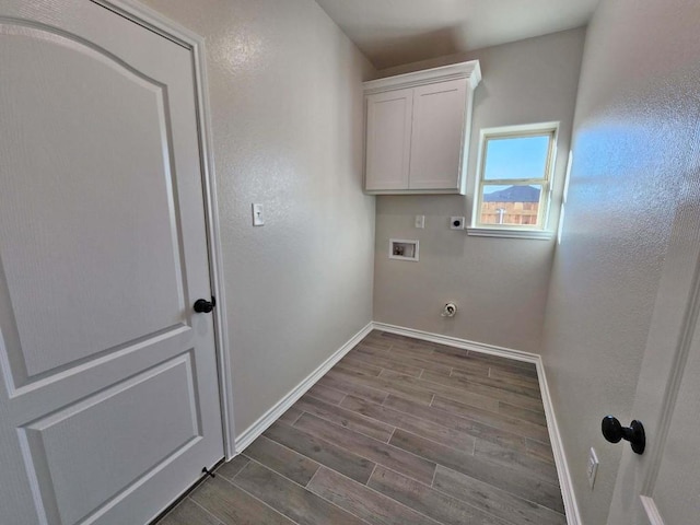 clothes washing area with cabinets, electric dryer hookup, and hookup for a washing machine