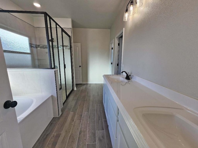 bathroom featuring vanity and plus walk in shower