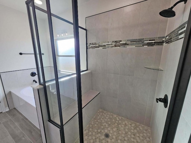 bathroom with shower with separate bathtub