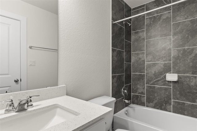 full bathroom with vanity, tiled shower / bath combo, and toilet