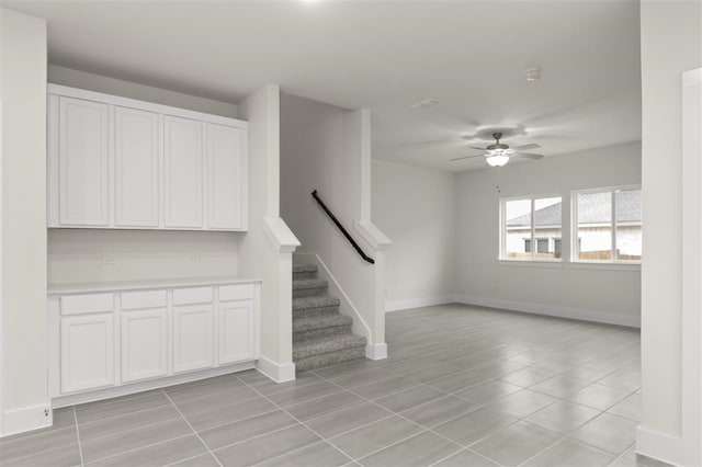 interior space featuring tile patterned floors and ceiling fan