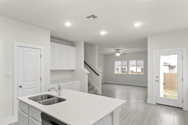 kitchen featuring sink, ceiling fan, an island with sink, white cabinets, and stainless steel dishwasher