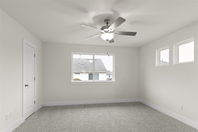 carpeted spare room with ceiling fan