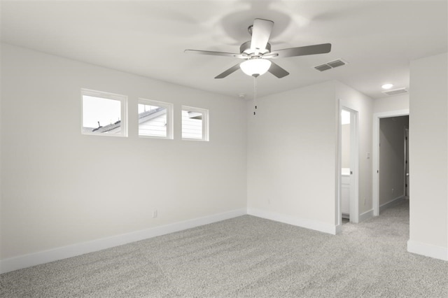 carpeted spare room featuring ceiling fan