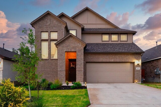1632 Stone House, New Braunfels, TX 78132 - view of front of property with brick siding, a garage, driveway, a lawn, and board and batten siding