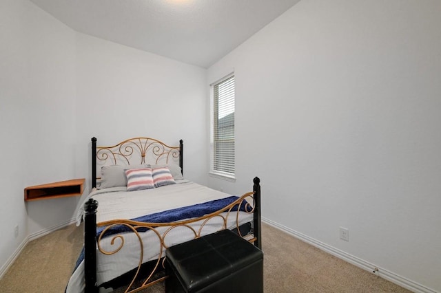 carpeted bedroom featuring lofted ceiling