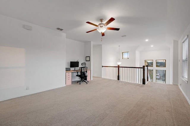 unfurnished office featuring light carpet and ceiling fan