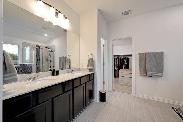 1632 Stone House, New Braunfels, TX 78132 - bathroom with double vanity, a stall shower, a spacious closet, and lofted ceiling
