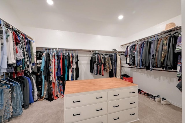 walk in closet with light carpet